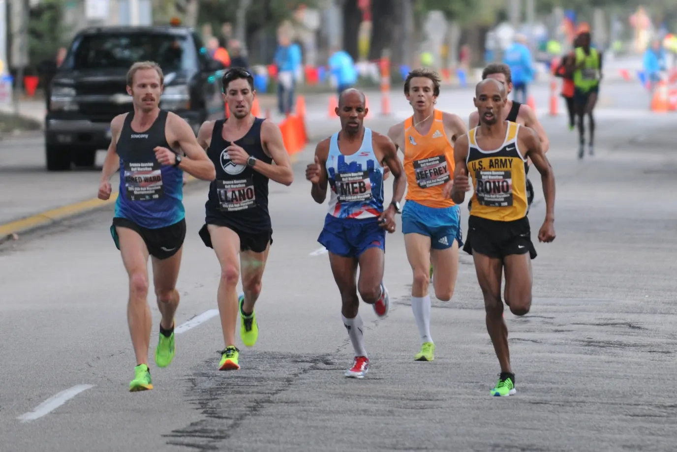 Meb Keflezighi and the lead pack of the 2015 Aramco Houston Half Marathon on a Houston street