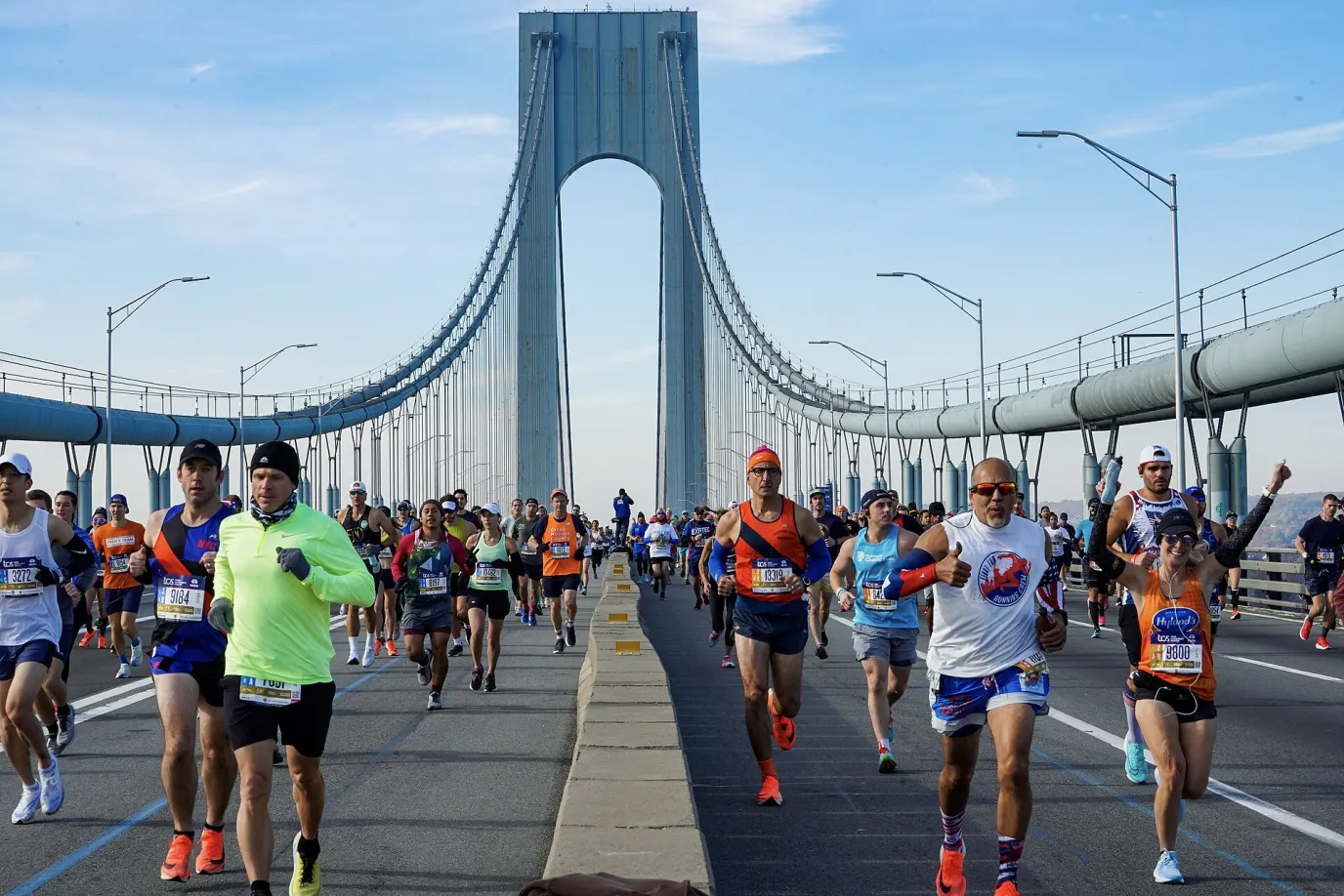 Marathoners crossing the Verrazzano-Narrows Bridge under one of its towers during the 50th New York City Marathon in 2021